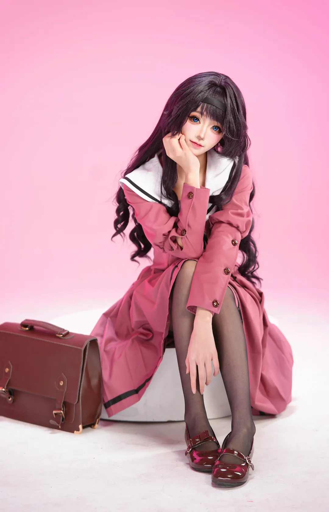 Pink sailor suit cosplay, Anime-style girl photo, Black hair and blue eyes style, Solid color background studio photography, School JK uniform